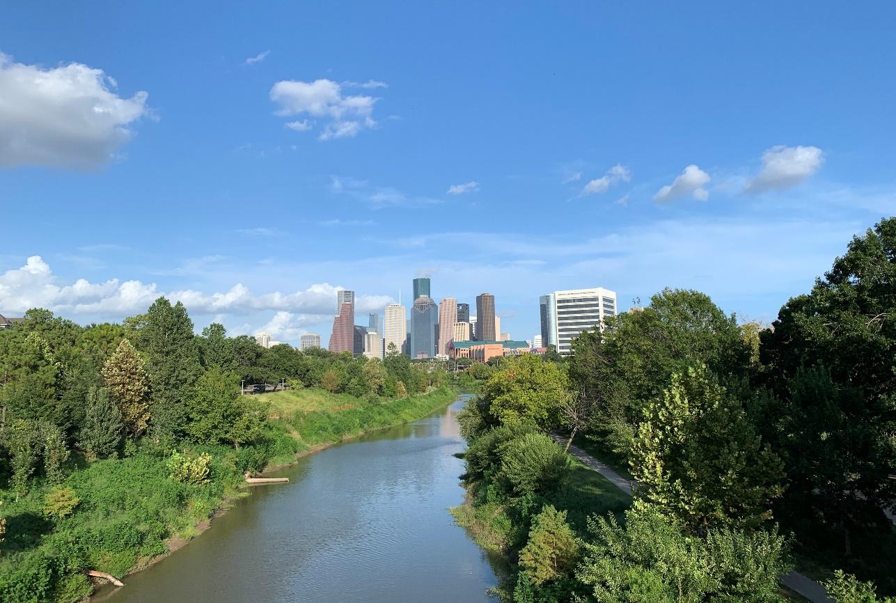 A view of the downtown Houston skyline with Buffalo Bayou in the foreground.